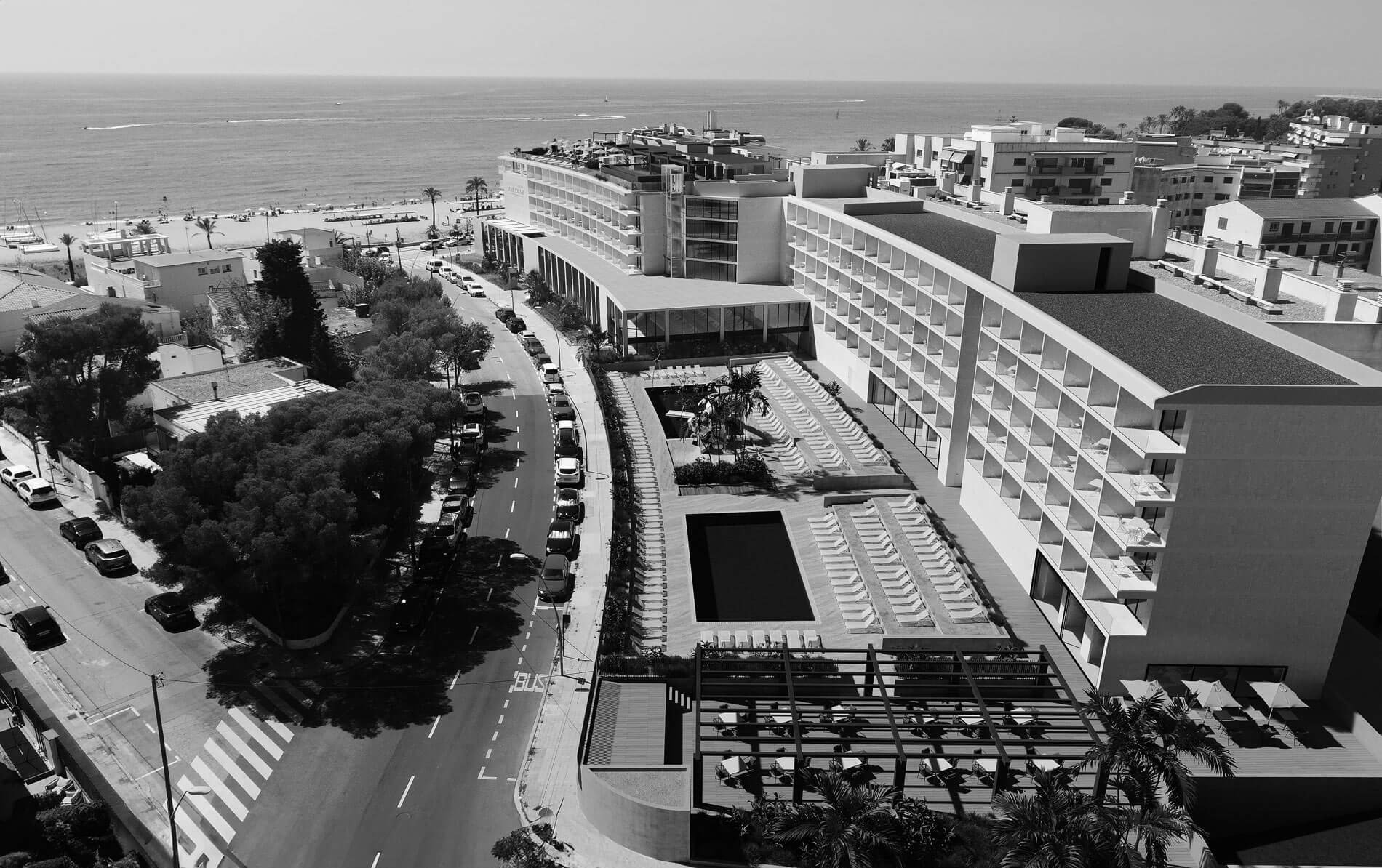 a black and white photo of a hotel with a pool=s1900