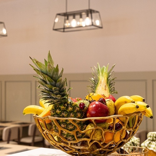 a bowl of fruit with a pineapple in it