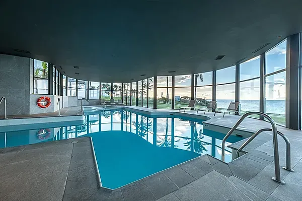 ESTIVAL: Corporate indoor pool with sea views and loungers.