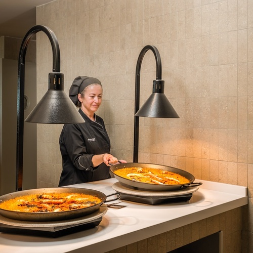 a woman in a chef 's uniform is preparing food