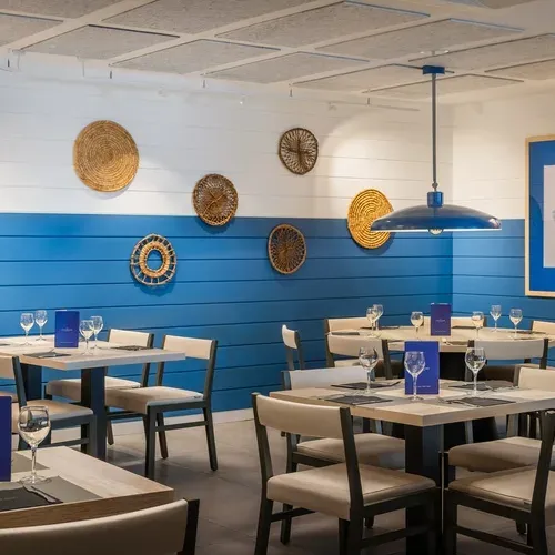 ESTIVAL: Corporativa dining room with tables set for a meal and blue and white decor.