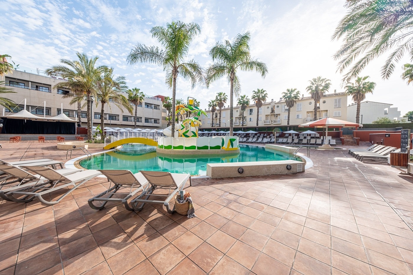 people are playing in a water park with a water slide