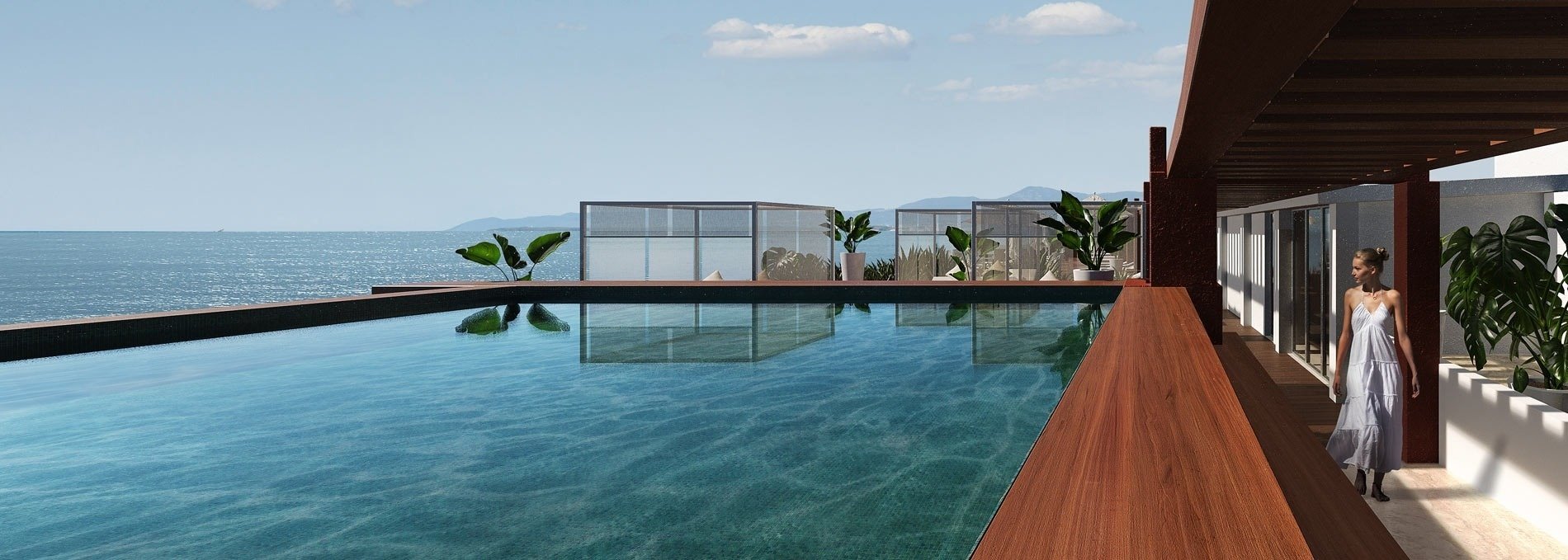 a woman in a white dress stands next to a swimming pool overlooking the ocean