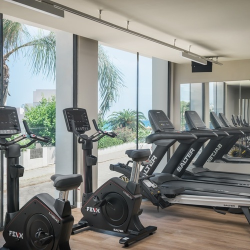a row of treadmills in a gym with one that says salter