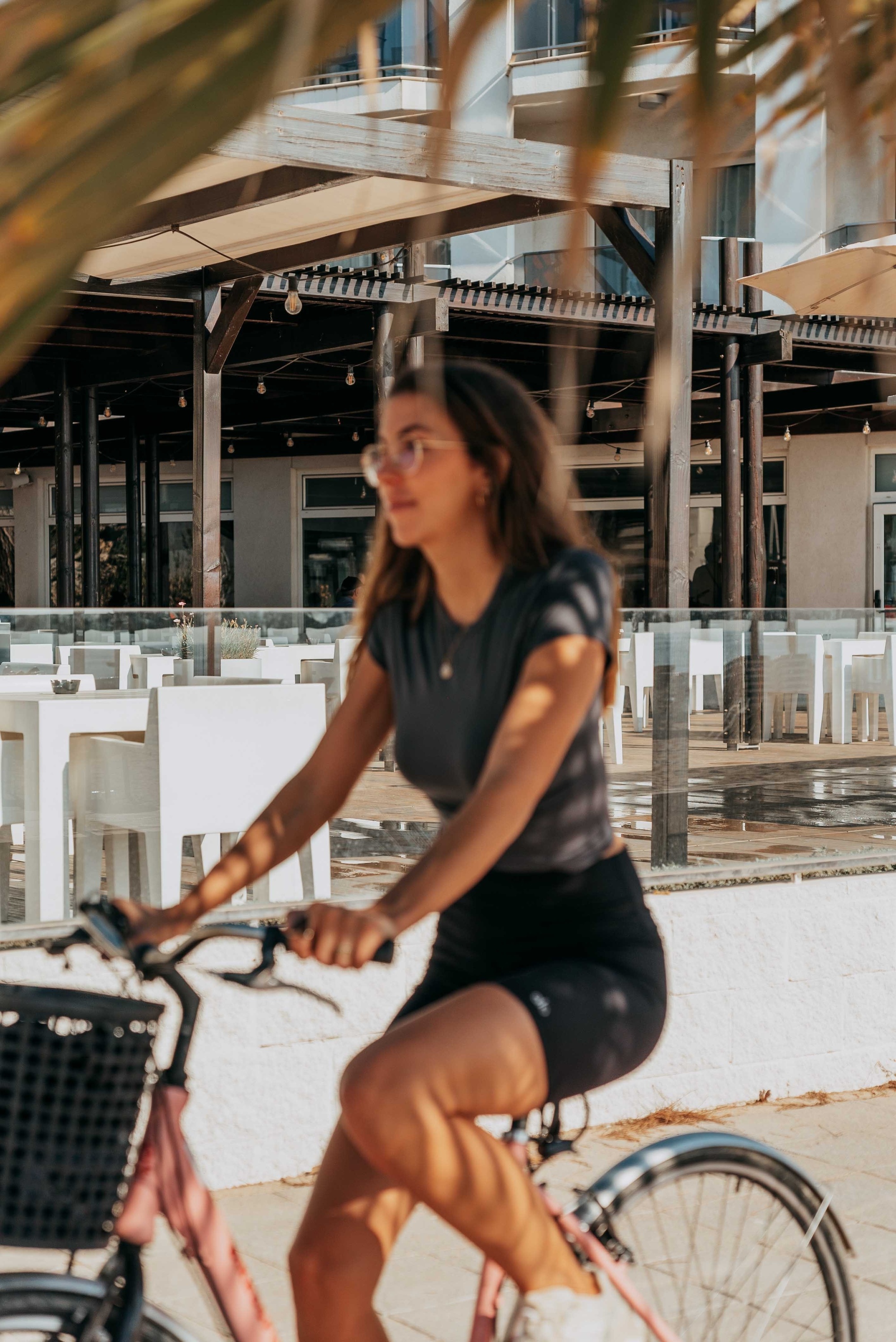 Two golfers, a man and a woman, walk side-by-side across a lush green golf course, both carrying golf bags.