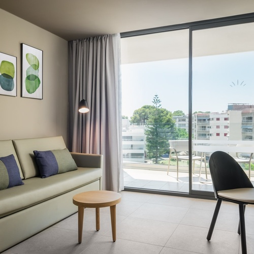 a hotel room with a couch and a table