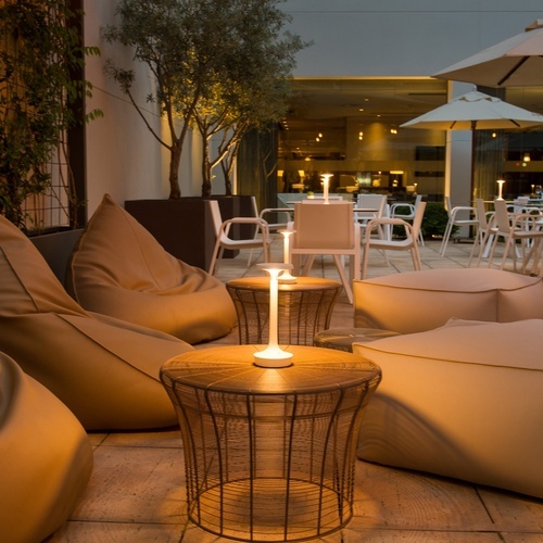 a patio with bean bag chairs and a table with a candle on it