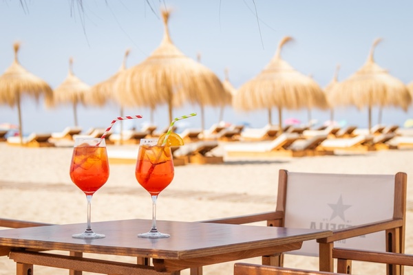 a row of chairs and umbrellas on a beach