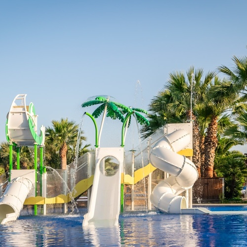 a water park with a slide and palm trees