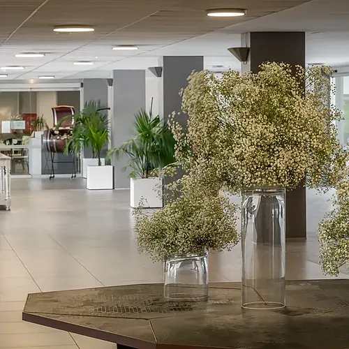 ESTIVAL Corporate lobby with fresh floral arrangements and modern decor.