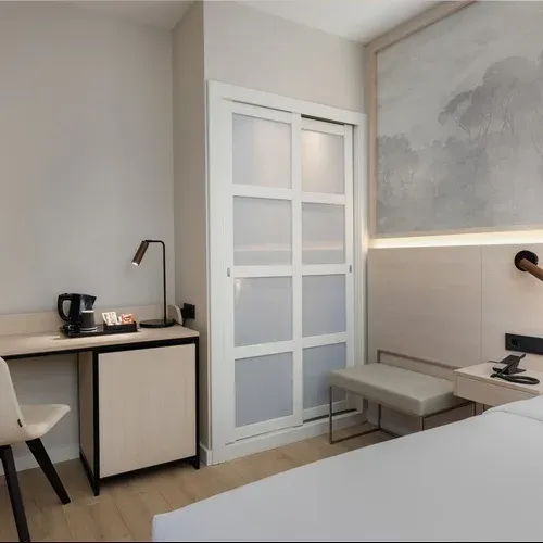 Hotel Vilamari Barcelona: Modern desk, TV, and comfy chair in a stylish hotel room.