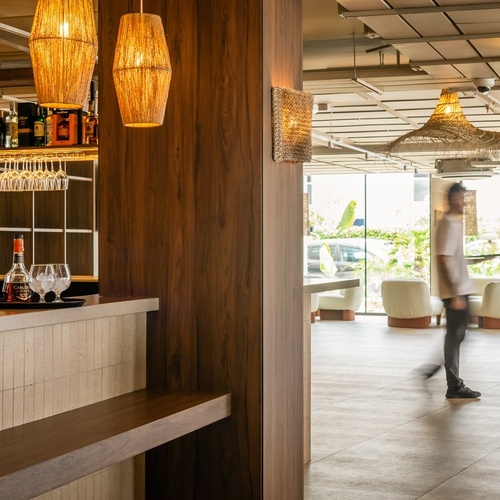 a blurred image of a woman walking in a restaurant