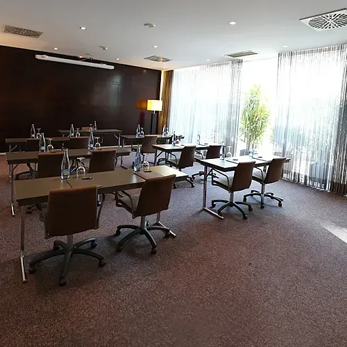 Hotel Vilamari Barcelona conference room setup with tables and chairs, perfect for meetings.