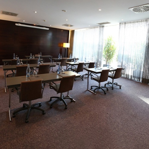 a conference room with tables and chairs set up for a meeting