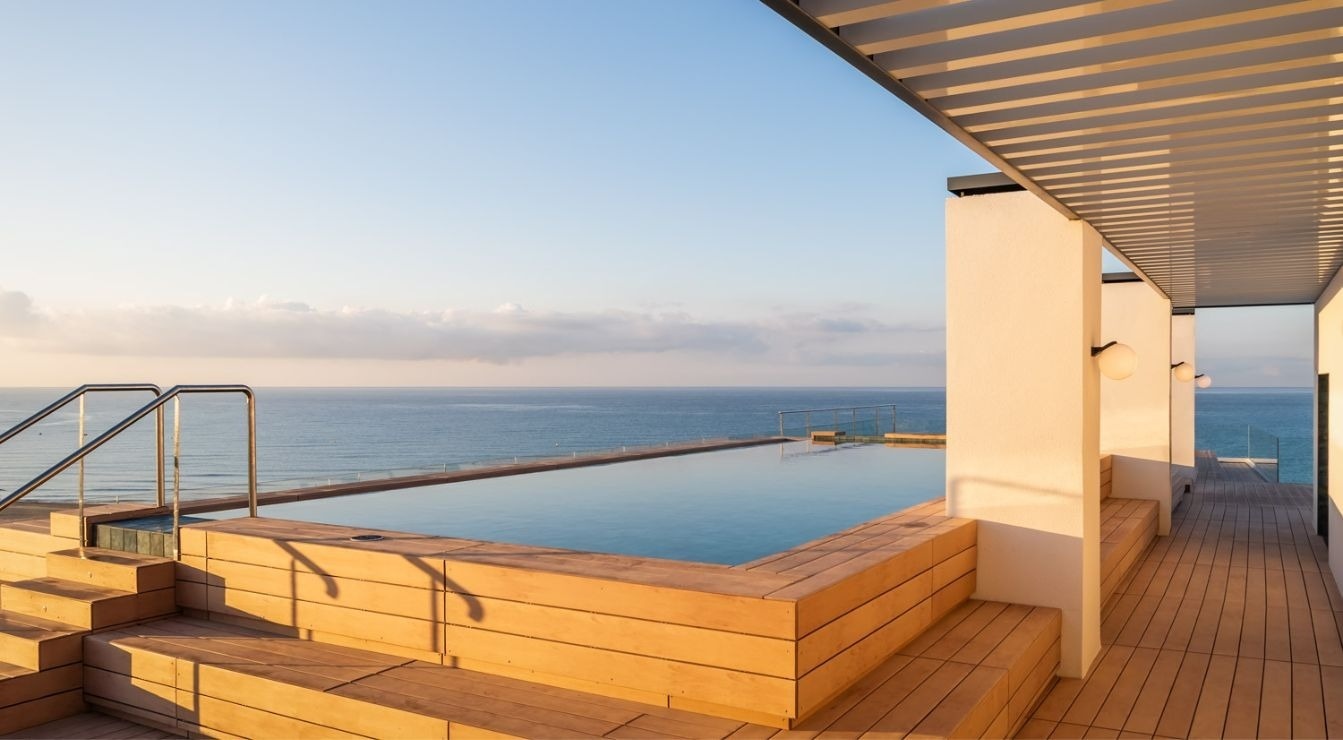 an aerial view of a swimming pool overlooking the ocean