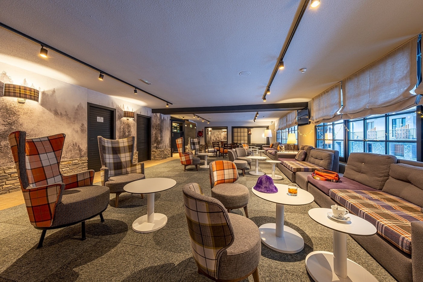 a room with chairs and tables with a chess board on one of them