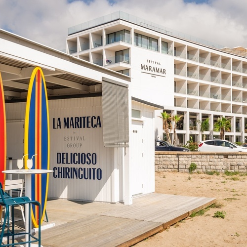 a surfboard sits in front of a building that says la mariteca