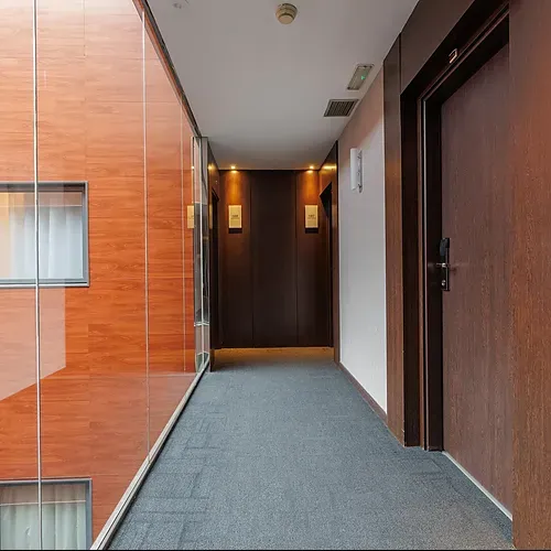 Hotel corridor with wood accents and elegant doors at Hotel Vilamari Barcelona.