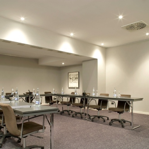 a conference room with tables and chairs set up for a meeting