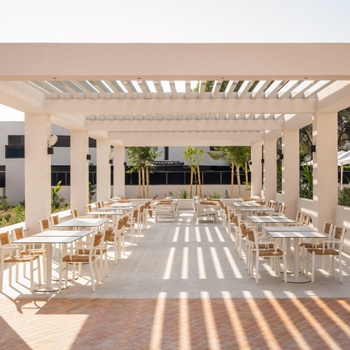 an aerial view of a hotel with a large pool in front of it