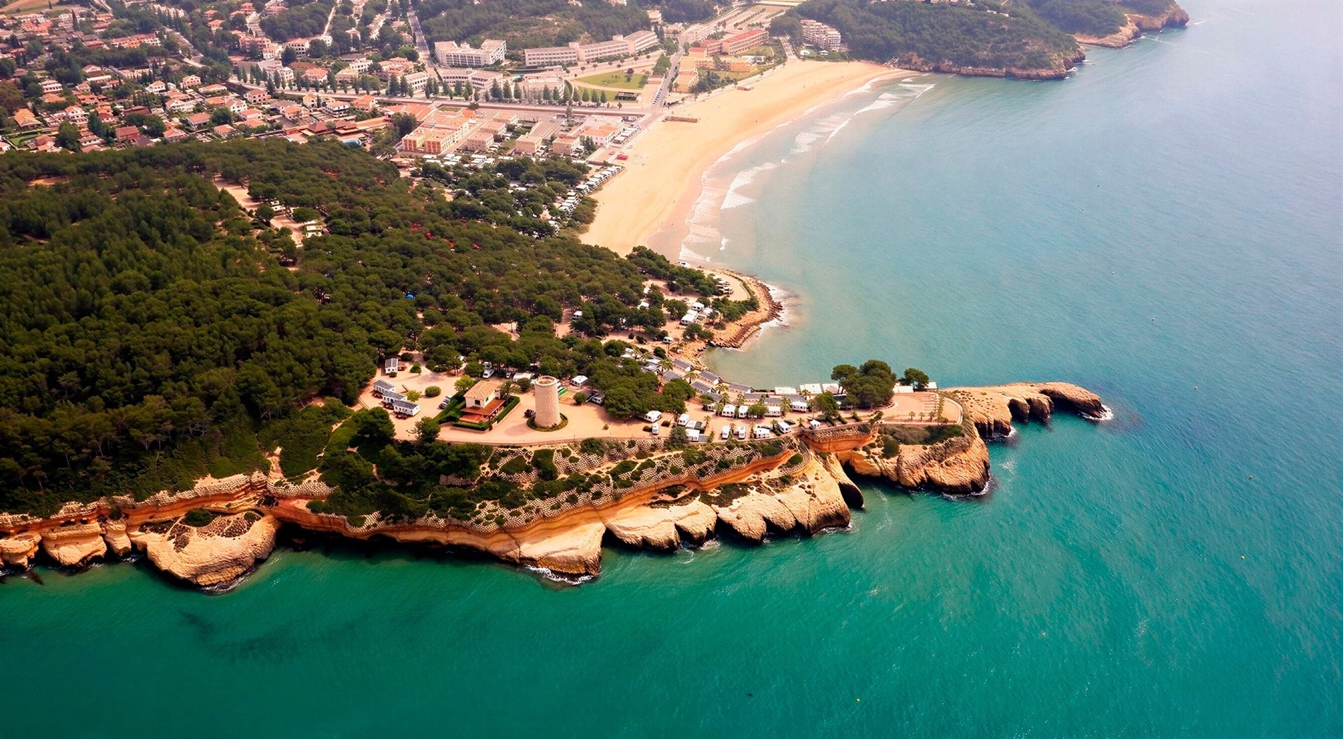 a bottle of wine sits on a balcony overlooking the ocean