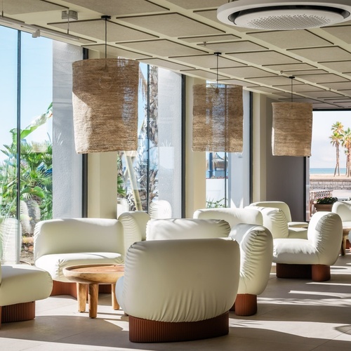 a room with a lot of white chairs and tables