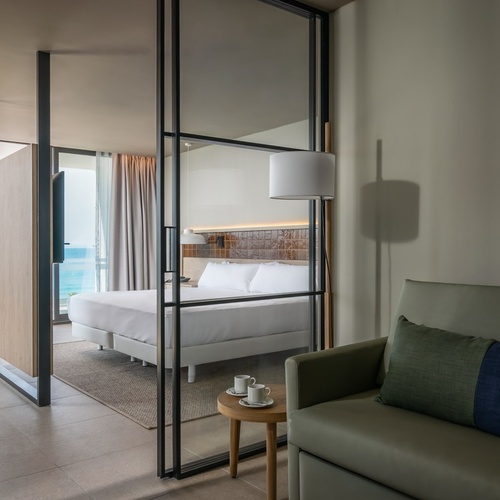 a hotel room with a couch and a bed