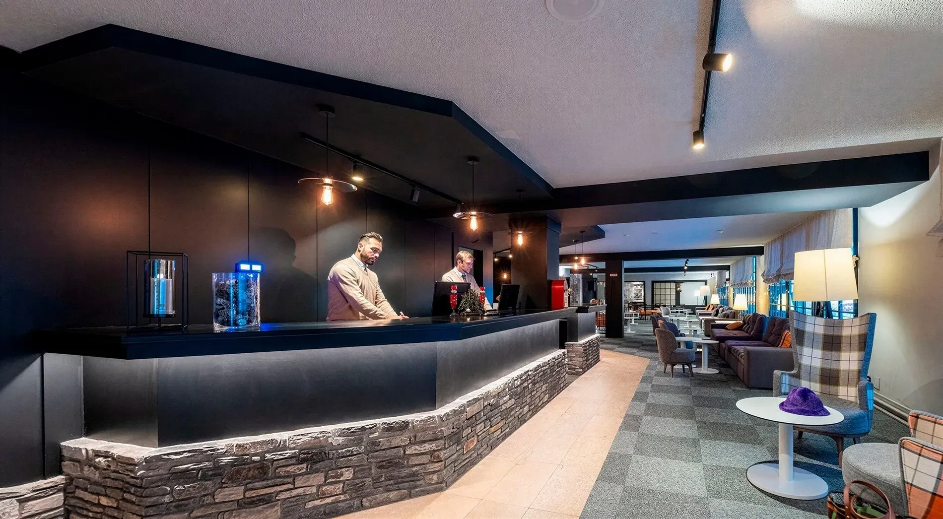 Hotel Cristina Andorra lobby with reception desk & seating area. FAQs | Estival Group.
