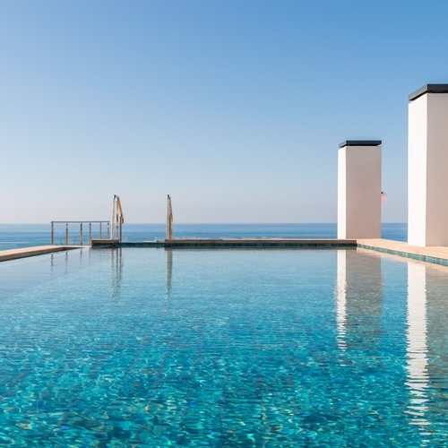 a large swimming pool with a view of the ocean
