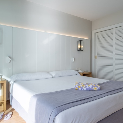 a hotel room with a bed and a nightstand