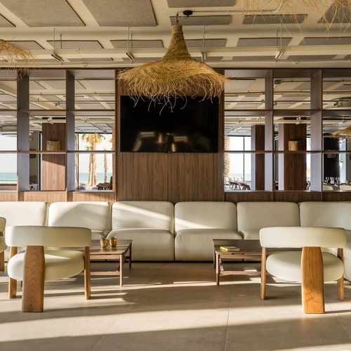 a room with a lot of chairs and a tv on the wall