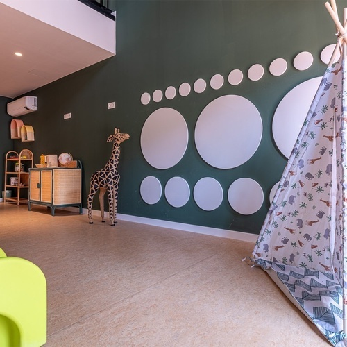 a room with a teepee and circles on the wall