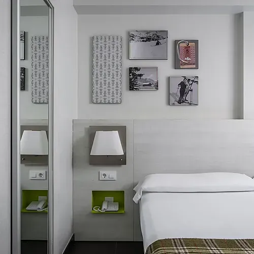Modern living area with sofa and yellow coffee table at Hotel Cristina | Andorra | Estival Group