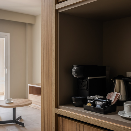 Modern hotel room with sofa, armchair, coffee maker, and sea view. Estival Park Almaris | Estival Group | Tarragona | Official Web.