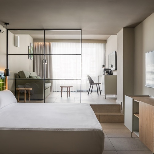 a hotel room with a large bed and a flat screen tv