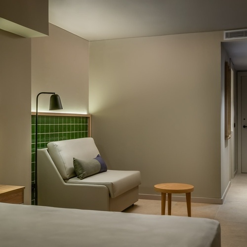 an artist 's impression of a hotel room with a large bed