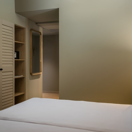 an artist 's impression of a hotel room with a large bed