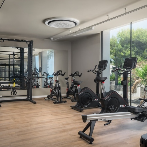a gym with exercise bikes and a treadmill that says fly