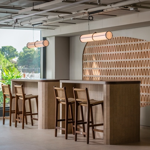 a row of bar stools are lined up in front of a large window