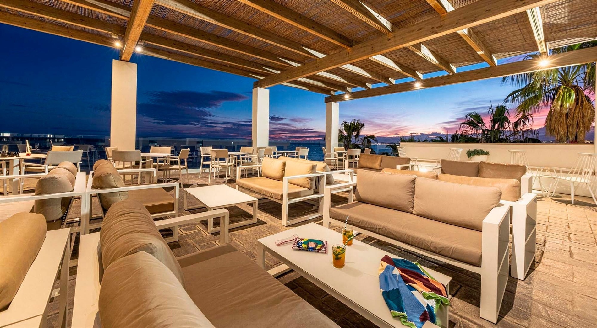 an aerial view of a large swimming pool surrounded by palm trees