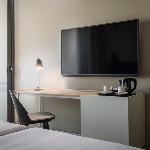 a living room with a couch a desk and a television