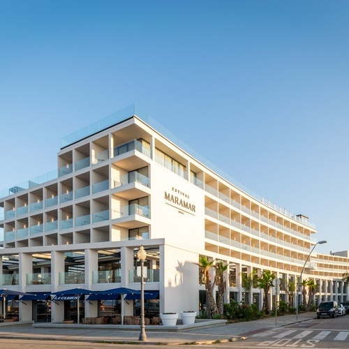 a red car is parked in front of a building that says stop