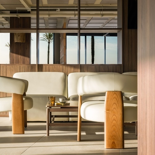 a room with white chairs and a wooden table