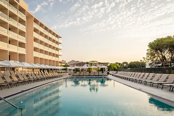 ESTIVAL: Corporativa pool with lounge chairs in sunset light.