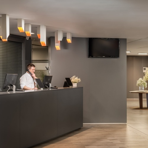 un hombre y una mujer están en la recepción de un hotel