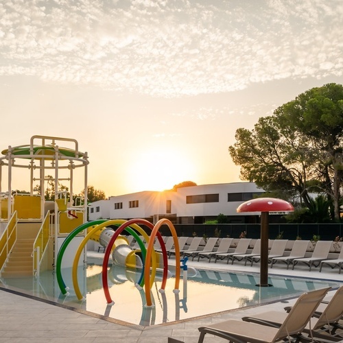 a swimming pool with a water slide and a mushroom umbrella