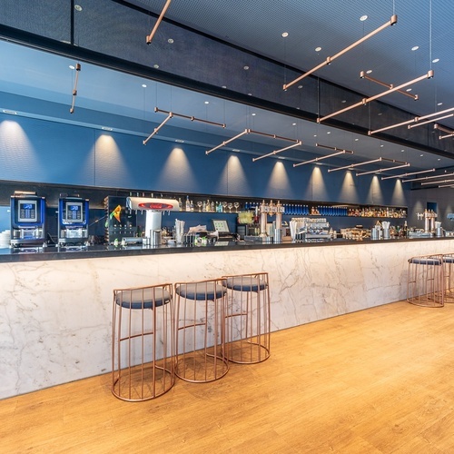 a bar with stools and a machine that says ' coca cola ' on it