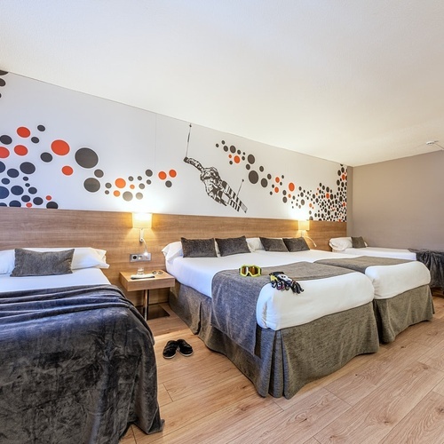 a hotel room with two beds and a television