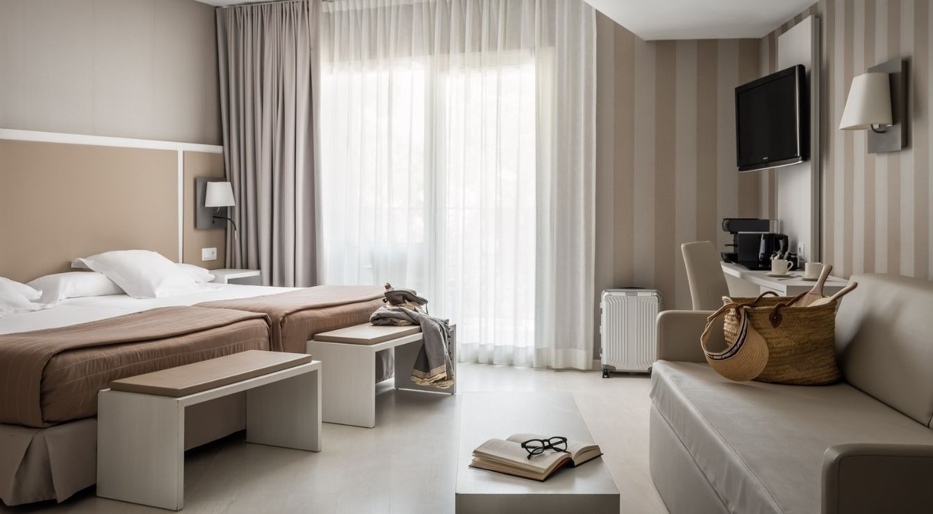 two chairs and a table on a balcony overlooking the ocean