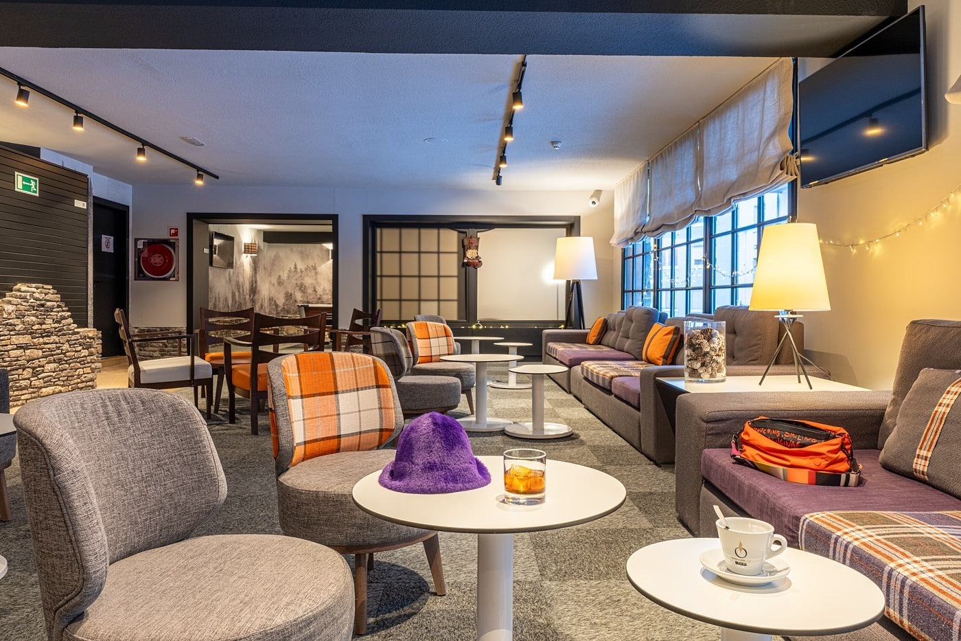 a table with two drinks and a candle on it